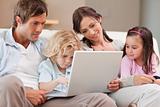 Calm family using a laptop