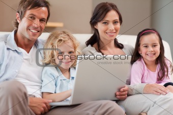 Calm family using a notebook