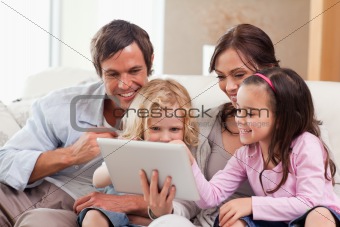 Delighted family using a tablet computer