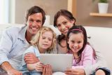 Charming family using a tablet computer