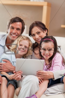 Portrait of a family using a tablet computer