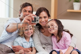 Father taking a picture of his family