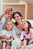 Portrait of a happy father taking a picture of his family
