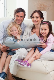 Portrait of a family looking at a photo album