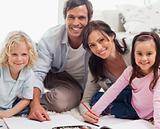 Smiling family drawing together