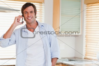 Smiling man making a phone call