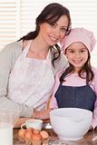 Portrait of a mother and her daughter baking
