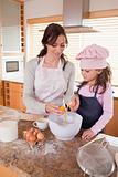 Portrait of a happy mother and her daughter baking