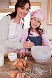 Portrait of a happy mother baking with her daughter