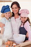 Portrait of a mother and her children baking