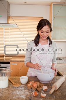 Portrait of a smiling woman baking
