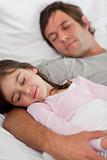 Portrait of a father sleeping with his daughter