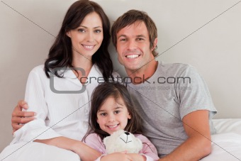 Parents posing with their daughter