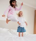 Portrait of playful siblings jumping