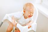 Crying baby in baby chair