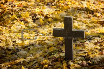 A cross monument in a cemetery