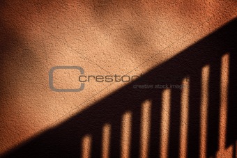 Shadow of a fence on  wall