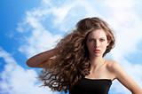 brunette with creative hairstyle in sky