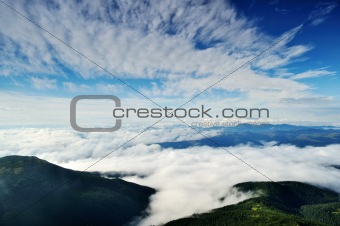 Landscape with mountains under morning sky with clouds