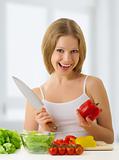 happy girl preparing vegetarian food, vegetables in the kitchen