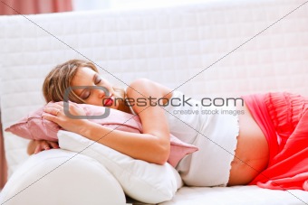 Pretty pregnant woman sleeping on sofa
