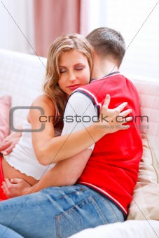 Beautiful pregnant woman hugging her husband
