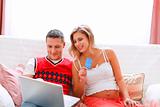 Happy young pregnant woman with husband making on-line purchases
