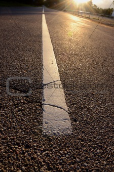 sunrise light on asphalt road