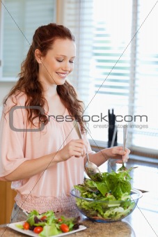 Woman stirring bowl of salad