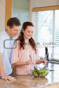 Man having a look at his girlfriends salad
