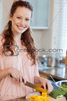 Woman cutting ingredients for salad