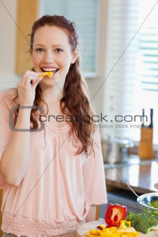 Woman eating bell pepper