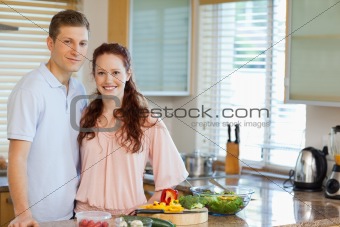 Couple standing behind kitchen counter