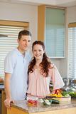 Young couple standing behind kitchen counter
