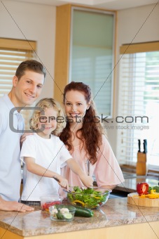 Young family preparing salad