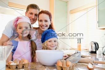 Cheerful family preparing dough