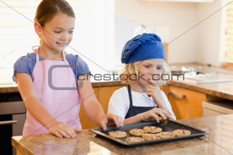 Siblings stealing cookies