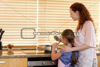 Mother and daughter cooking a meal