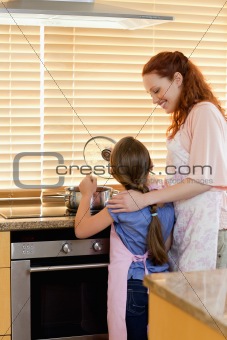 Mother and daughter preparing a meal
