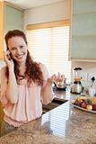 Woman on the phone next to the kitchen counter