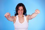 beautiful  woman with arms raised as victory signal, isolated on blue. studio shot