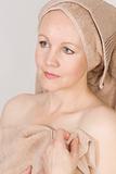 Adult beautiful woman after bath with a towel on her head. 