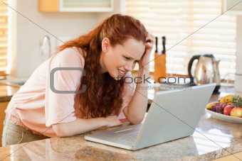 Woman looking confused at her laptop