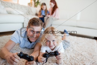 Father and son in the living room playing video games