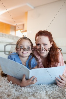 Mother and daughter with magazine on the the floor