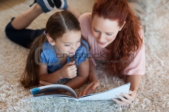 Mother and daughter on the carpet reading