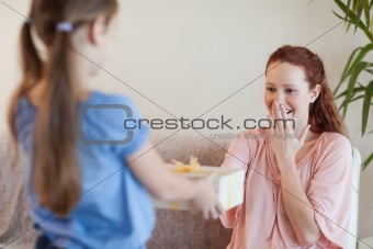 Mother being surprised by daughter with present