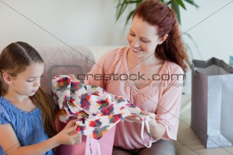 Mother and daughter with shopping on the sofa