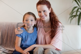 Happy mother and daughter on the sofa