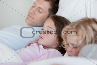 Father taking a nap with his children